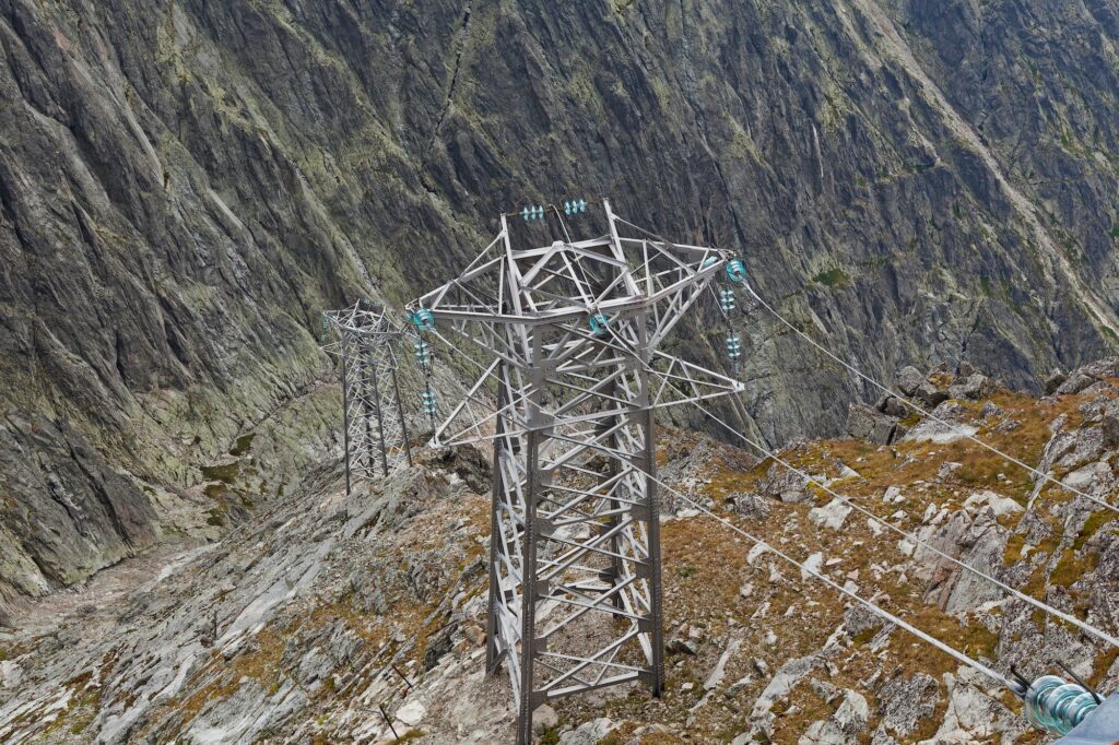 Electric power line in extremely high rocky mountains